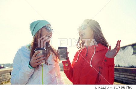 happy teenage girls with coffee cups on street 21796760