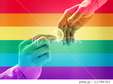close up of male gay couple hands giving condom close up of male gay couple hands giving condom 21796762