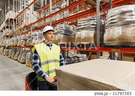 man on forklift loading cargo at warehouse man on forklift loading cargo at warehouse 21797263