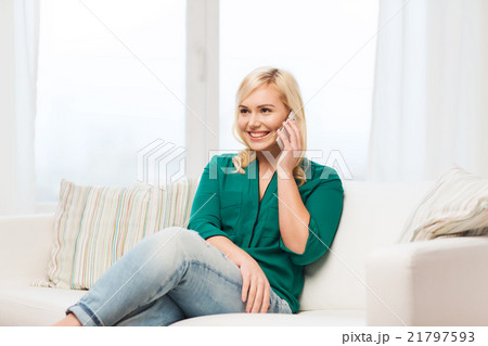 happy young woman calling on smartphone at home 21797593
