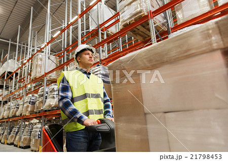 man on forklift loading cargo at warehouse man on forklift loading cargo at warehouse 21798453