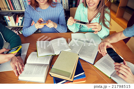 students with smartphones making cheat sheets 21798515