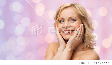 smiling woman with bare shoulders touching face smiling woman with bare shoulders touching face 21798762
