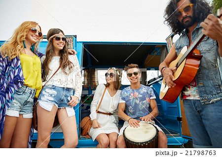 happy hippie friends playing music over minivan happy hippie friends playing music over minivan 21798763