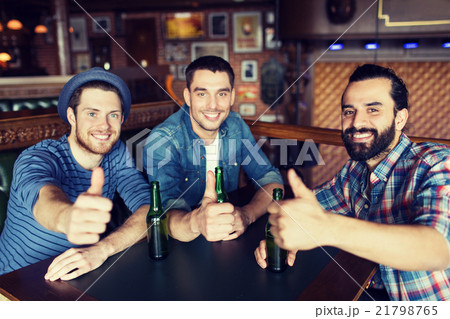 happy male friends drinking beer at bar or pub happy male friends drinking beer at bar or pub 21798765