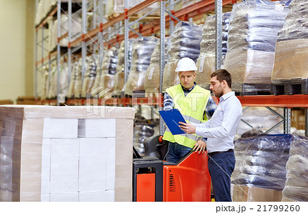 worker and businessmen with clipboard at warehouse worker and businessmen with clipboard at warehouse 21799260