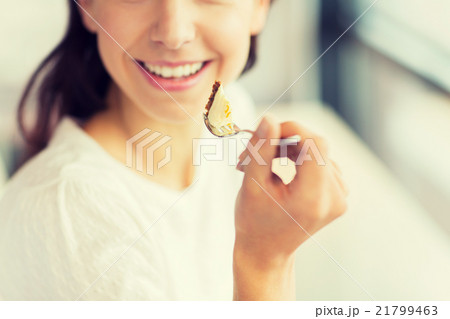 close up of woman eating cake at cafe or home close up of woman eating cake at cafe or home 21799463