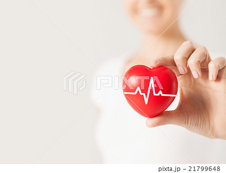 close up of hand with cardiogram on red heart close up of hand with cardiogram on red heart 21799648