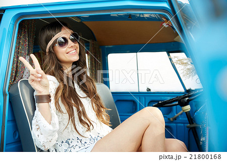 happy hippie woman showing peace in minivan car happy hippie woman showing peace in minivan car 21800168