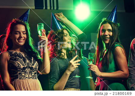 smiling friends with glasses of champagne in club smiling friends with glasses of champagne in club 21800169