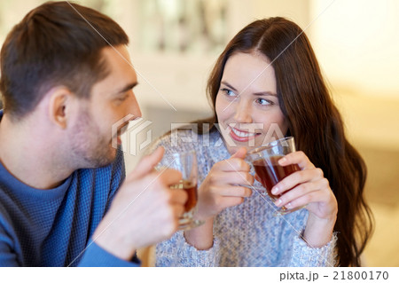 happy couple drinking tea at cafe 21800170
