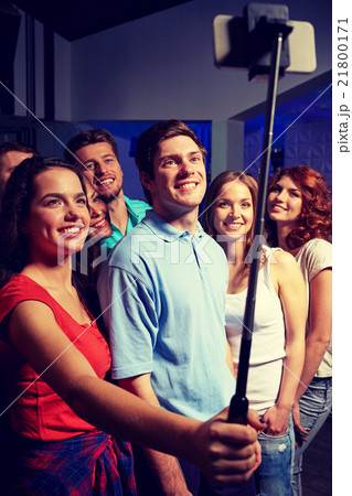 friends with smartphone taking selfie in club friends with smartphone taking selfie in club 21800171