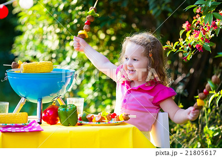 Little girl at garden grill party 21805617