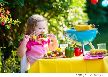 Little girl at garden grill party Little girl at garden grill party 21805750