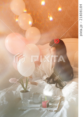 Girl eating breakfast in bed. Birthday. 21808184