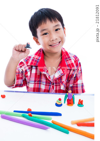 Child show his works from clay, over white. Child show his works from clay, over white. 21812091
