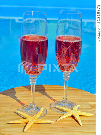 Two glasses with red wine on pool background Two glasses with red wine on pool background 21819875