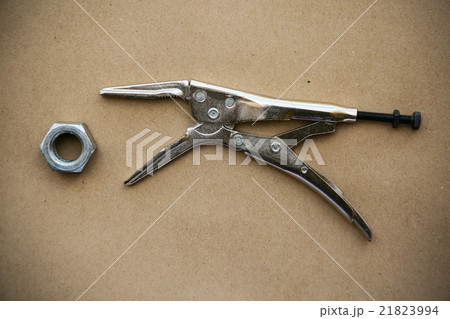close up locking pliers on wooden background 21823994