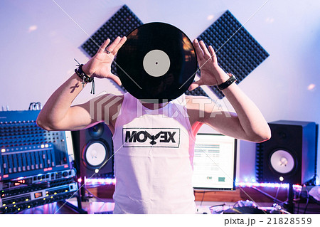 DJ holds vinyl record in recording studio DJ holds vinyl record in recording studio 21828559