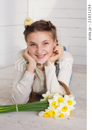 Teen girl with yellow baby chick on her head 21831294