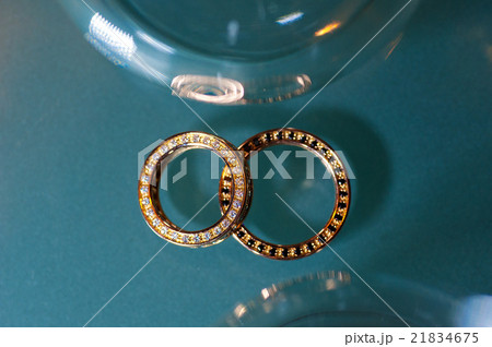 Two golden rings on turquoise glitter background Two golden rings on turquoise glitter background 21834675