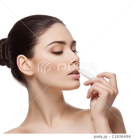 Beautiful girl applying chapstick Beautiful girl applying chapstick 21836494