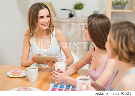 Positive girls sitting at the table Positive girls sitting at the table 21840025