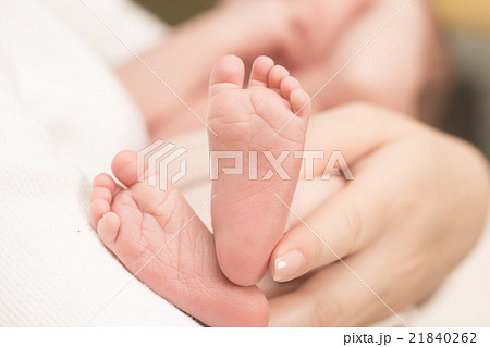 Baby feet in mother hands. 21840262