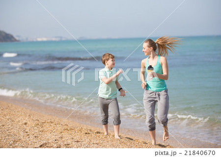 Mother with son running on the beach Mother with son running on the beach 21840670