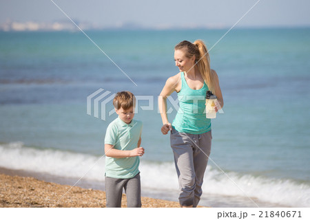 Mother with son running on the beach Mother with son running on the beach 21840671