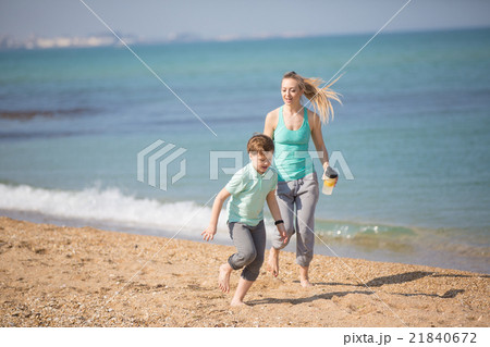 Mother with son running on the beach Mother with son running on the beach 21840672
