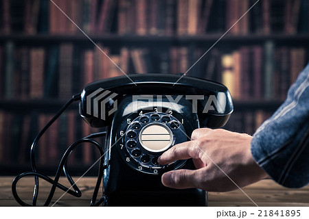 黒電話のダイヤルを回す男性の手 21841895