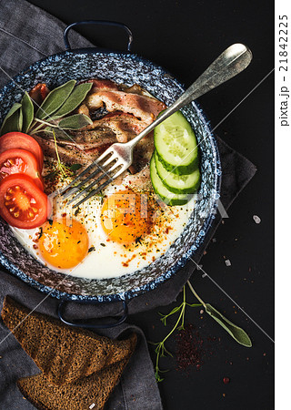 Breakfast set. Pan of fried eggs with bacon, fresh Breakfast set. Pan of fried eggs with bacon, fresh 21842225
