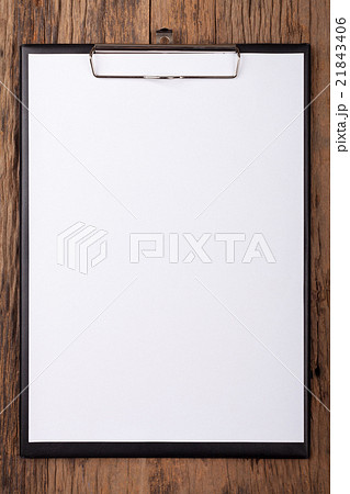 White paper on clipboard on wood background 21843406