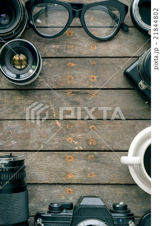 Old cameras and lens on wooden table, top view 21844802