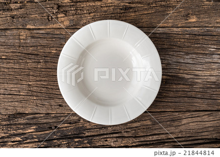 Empty white plate on wooden table 21844814