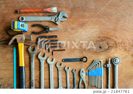 Set of work tools on old grunge wood background 21847761