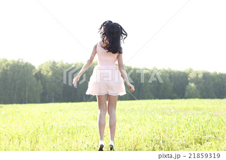 The girl pink dress is jumping meadow summer 21859319