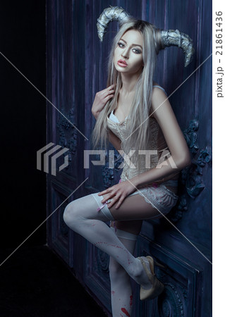 Beautiful blonde woman with horns. 21861436