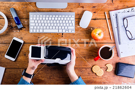 Businessman working at office desk holding virtual Businessman working at office desk holding virtual 21862604