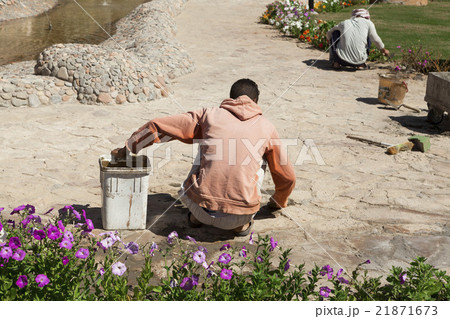 The builder, gardener is working on  repair tracks 21871673