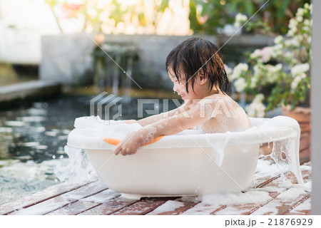 Cute asian child bathing in the garden Cute asian child bathing in the garden 21876929