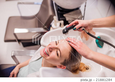 Unrecognizable professional hairdresser washing Unrecognizable professional hairdresser washing 21881284