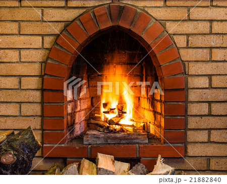 open fire in indoor brick fireplace 21882840