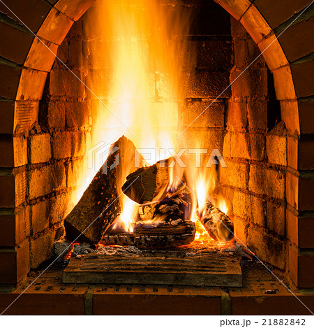 open fire in fire-box of brick fireplace 21882842