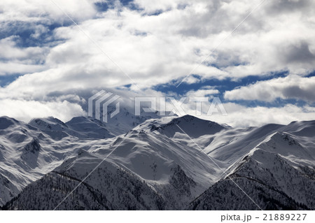 View on snowy mountains and cloudy sky at evening 21889227