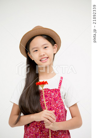 Portrait of little Asian child smiling with flower Portrait of little Asian child smiling with flower 21892339