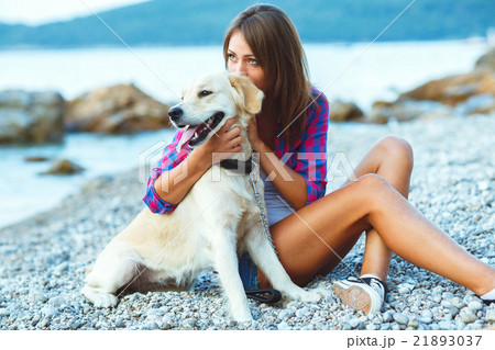 Summer vacation, woman with a dog on a walk on the beach Summer vacation, woman with a dog on a walk on the beach 21893037