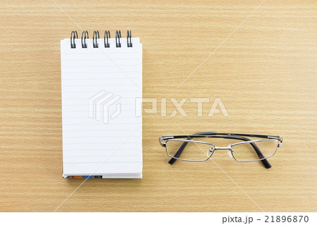 Eyeglasses and Notepad with blank page 21896870