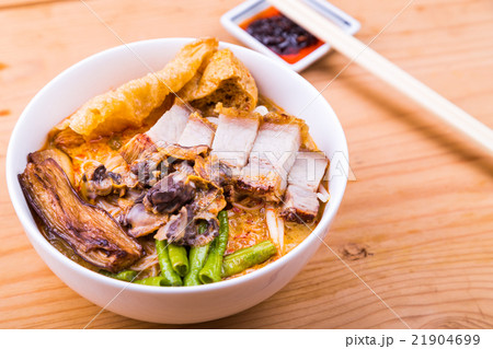 Spicy curry noodle with roast pork and cockles Spicy curry noodle with roast pork and cockles 21904699